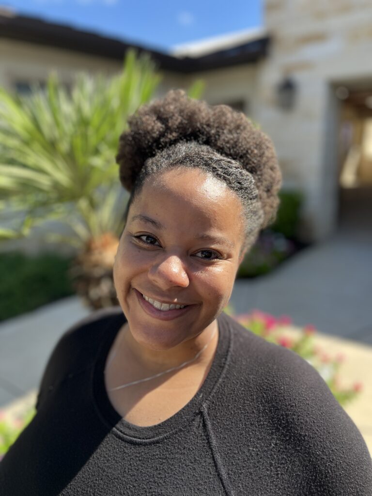 Picture of Carina Richards, LCSW, AMA Associate in front of AMA Behavioral Therapy building.